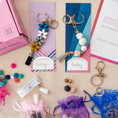 Kids Entrepreneurship Kit by Kids Crafts: A hands-on DIY Keychain Craft Set that teaches children ages 8+ the basics of business skills and financial literacy. The kit comes with beads, strings, and keychain hardware, packaged in a pink box. Ideal for family bonding, fostering creativity, and offering a fun STEM learning experience.