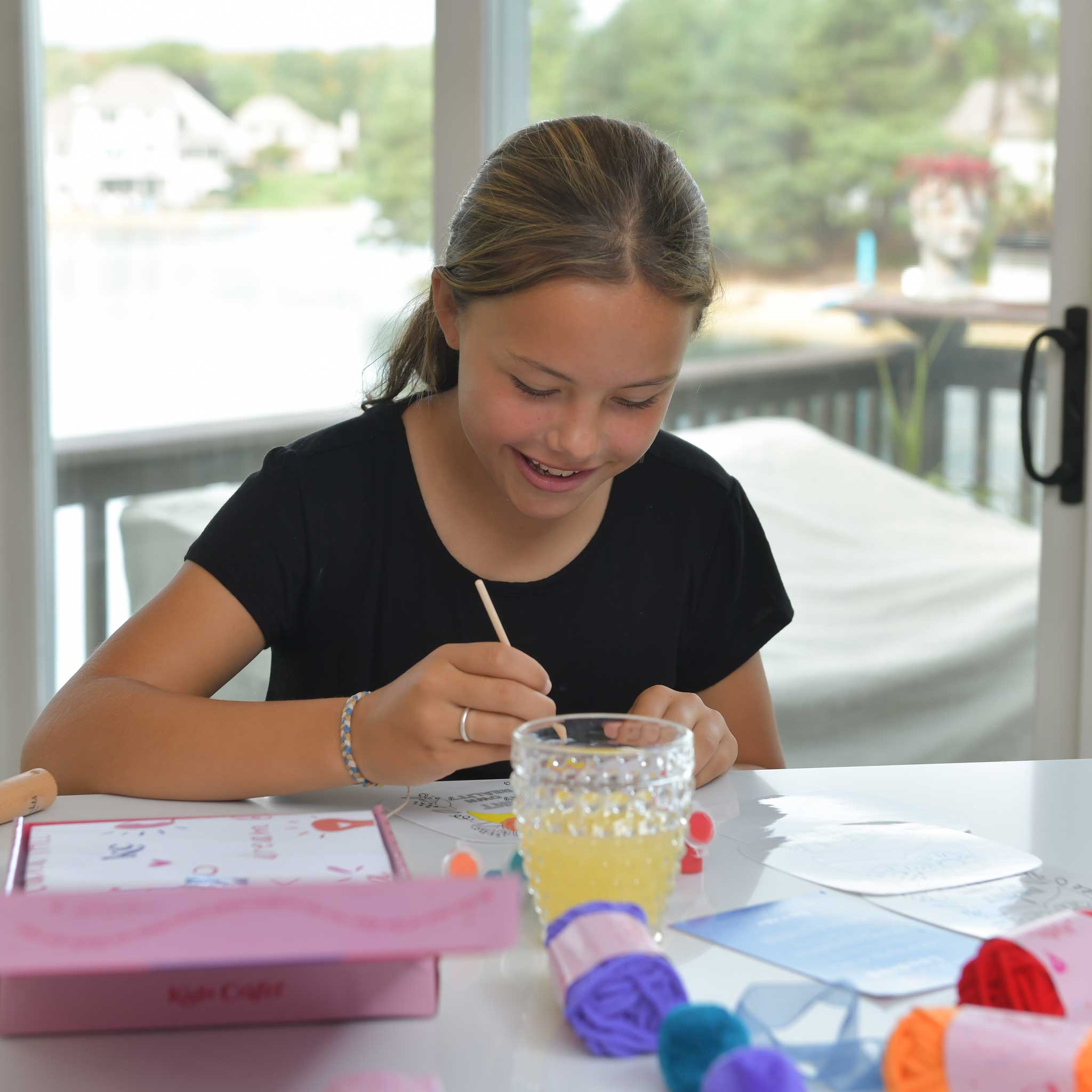 Young artist painting a self-portrait on a wooden-handled mirror with the Frida Kahlo Art Kit, an engaging educational activity that celebrates Mexican culture.