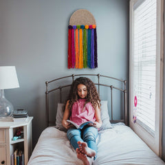 Inspirational Wall Decor Craft Kit for kids aged 8+, featuring a rainbow art project inspired by Maya Angelou's quote. Includes colorful tassels, a story about trailblazing women, and a conversation starter card on leadership, making it perfect for classrooms, bedrooms, and playrooms. Ideal as a diversity gift, birthday present, or Women's History Month activity.